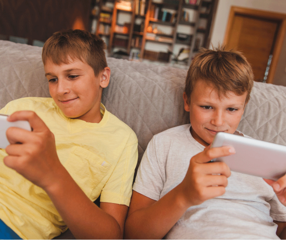 Internet parental controls protect two tween boys while they are playing on their smart phones.