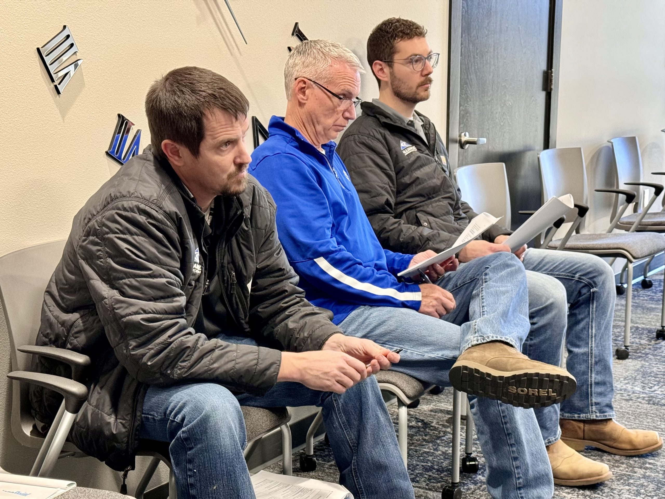 Alliance team members Tom Chase, Jeff Hove, and Charles Lawton listen to contractors review construction plans for rural Beresford's new fiber network.